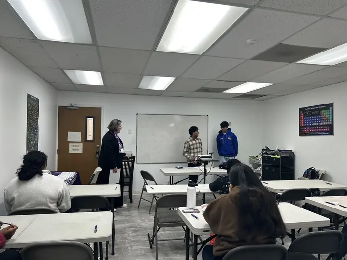 A classroom set up with tables and chairs for the competition.
