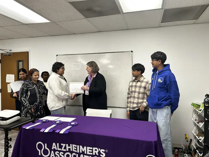 Competitors and organisers lined up behind the Alzheimer's Association table.
