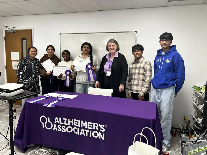 Finalists and organisers gathered behind the Alzheimer's Association table.