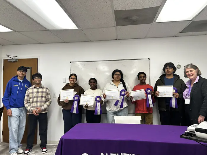 A large group of participants holding certificates after the awards ceremony.