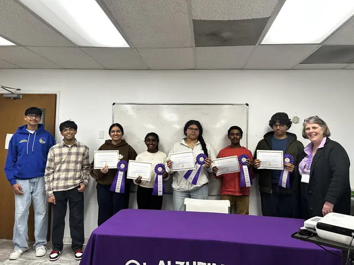 A group of participants and organisers holding certificates.
