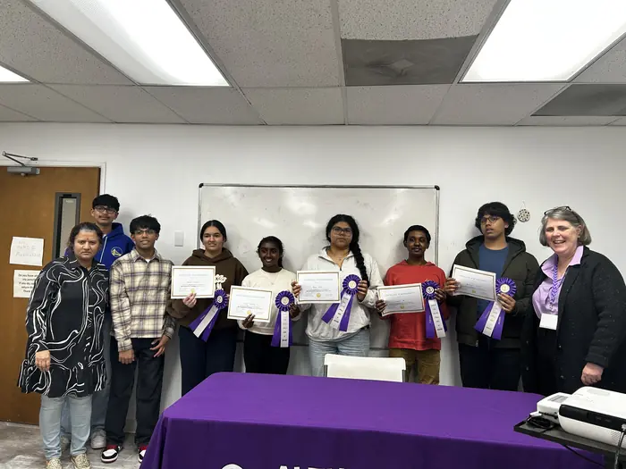 Participants holding certificates with organisers at the Alzheimer's Association table.